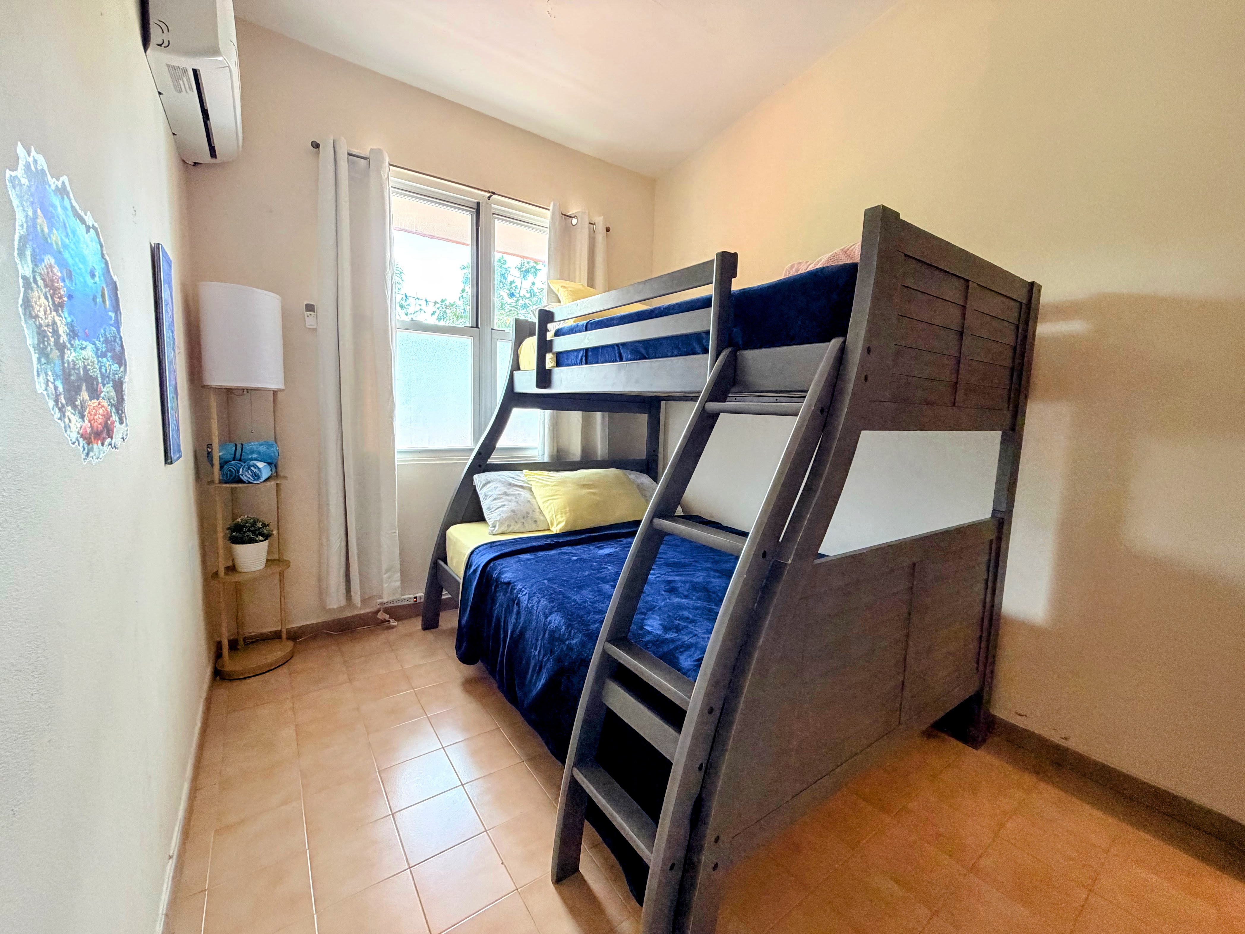 Cozy bunk room with A/C, natural light, and family-friendly sleeping space