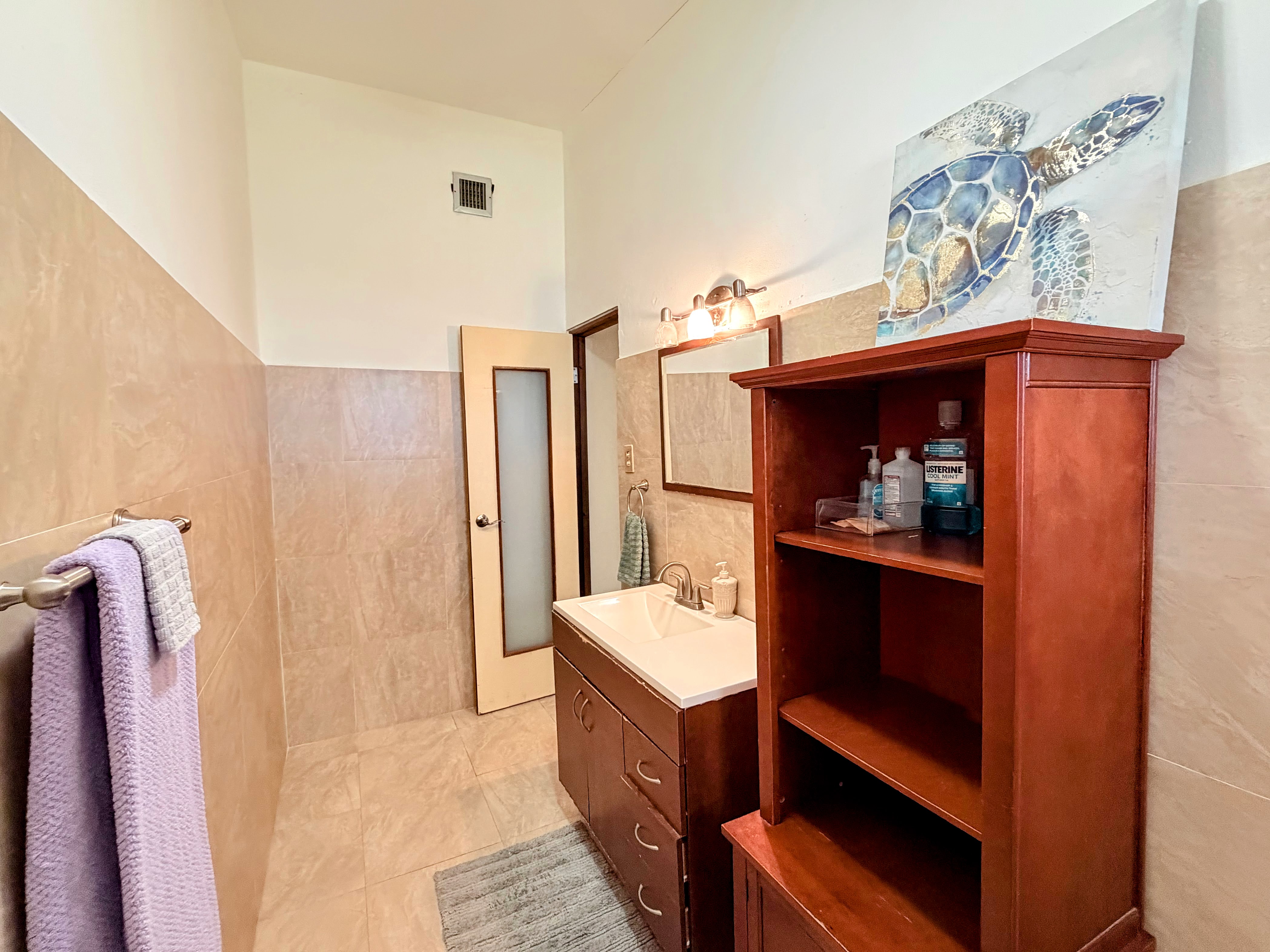 Bright, spacious bathroom with modern vanity and extra storage