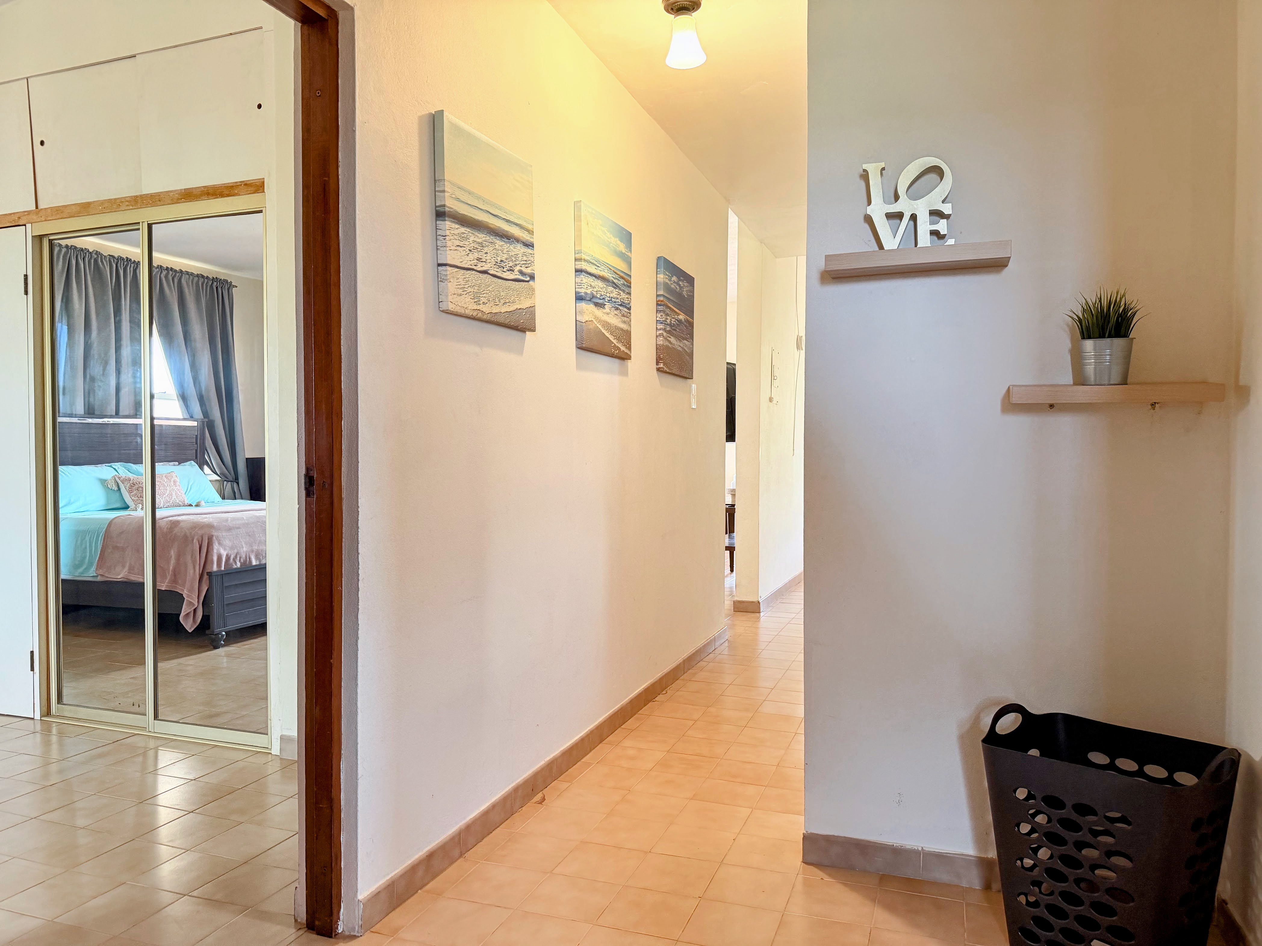 Bright hallway with coastal decor and easy access to a cozy bedroom
