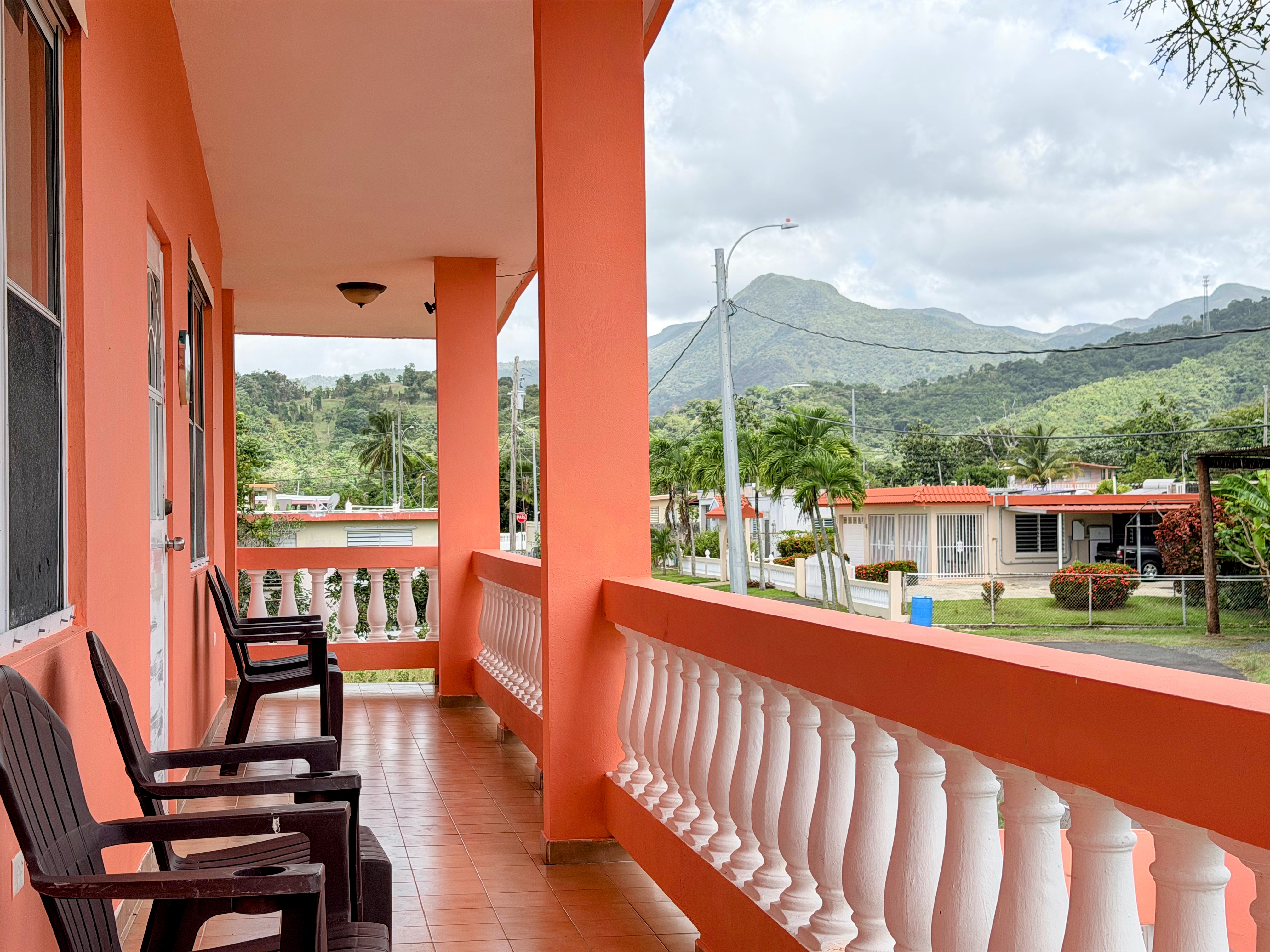 Scenic covered balcony with mountain views and relaxed outdoor seating