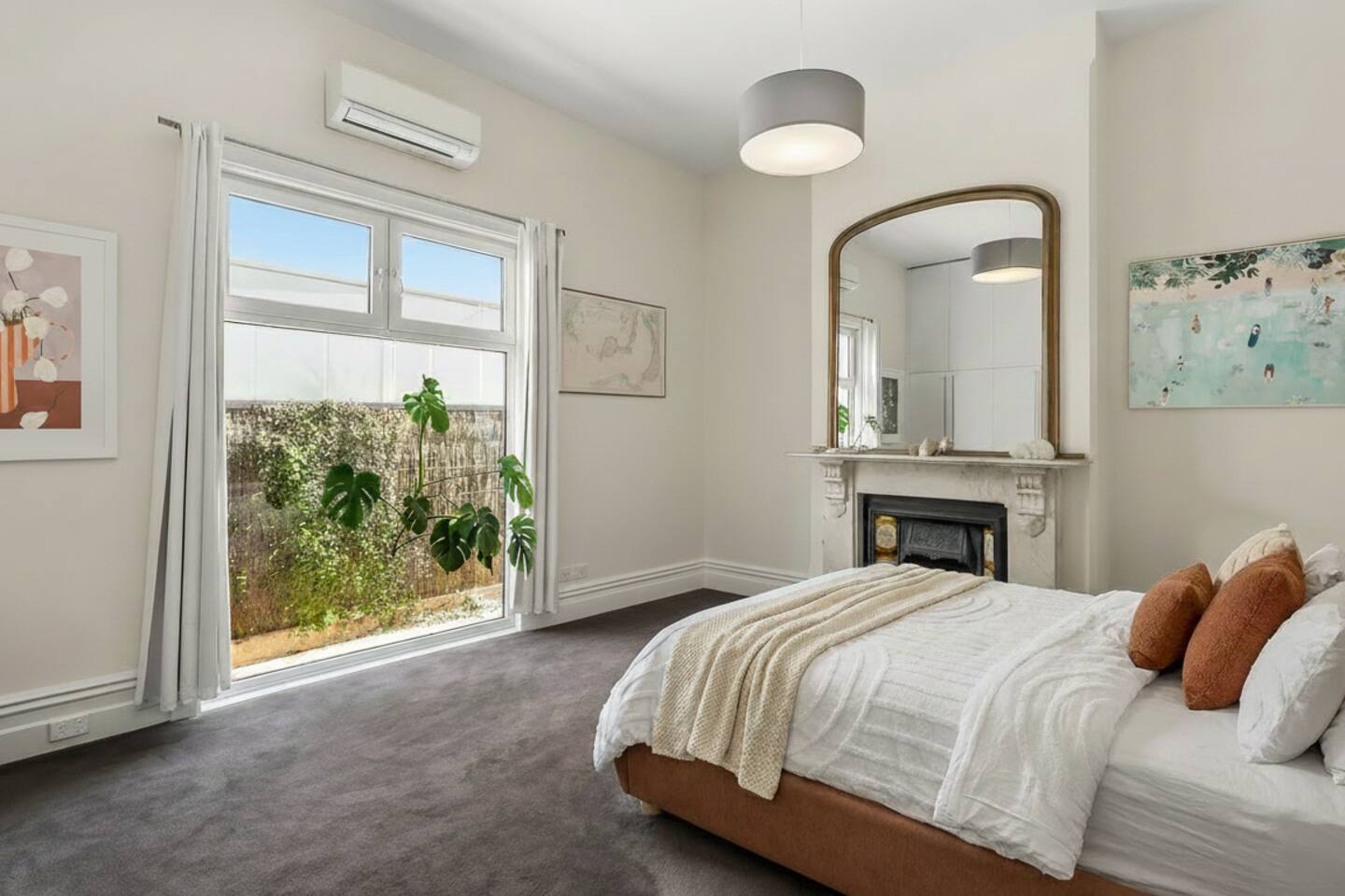 Queen bedroom in soft sage opening to a private courtyard