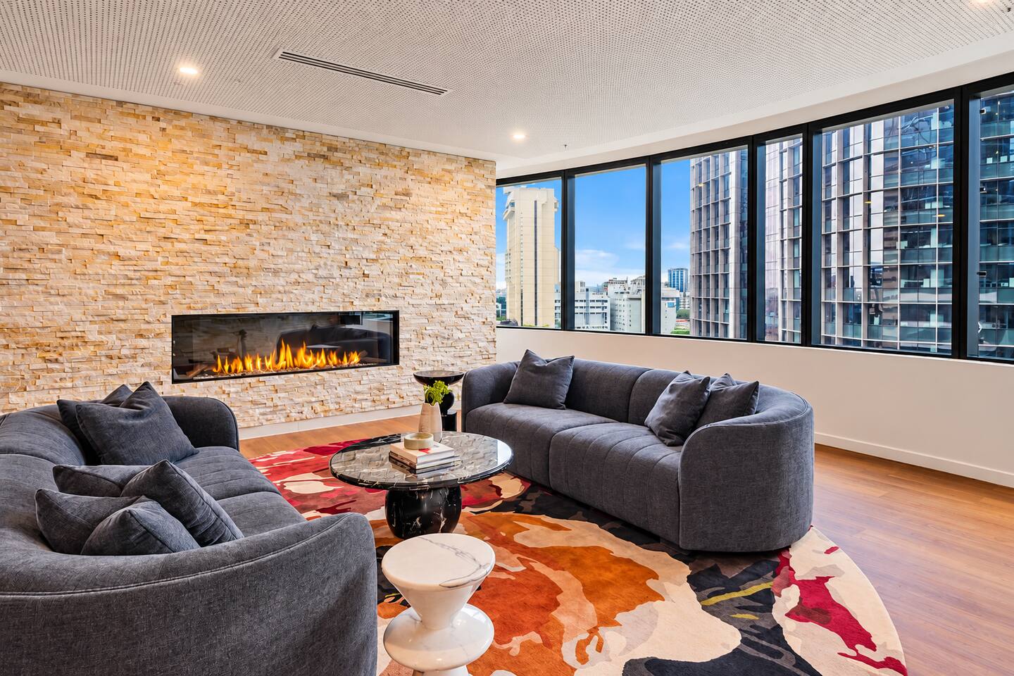 Common Area | Relax by the elegant fireplace and enjoy the city views.
