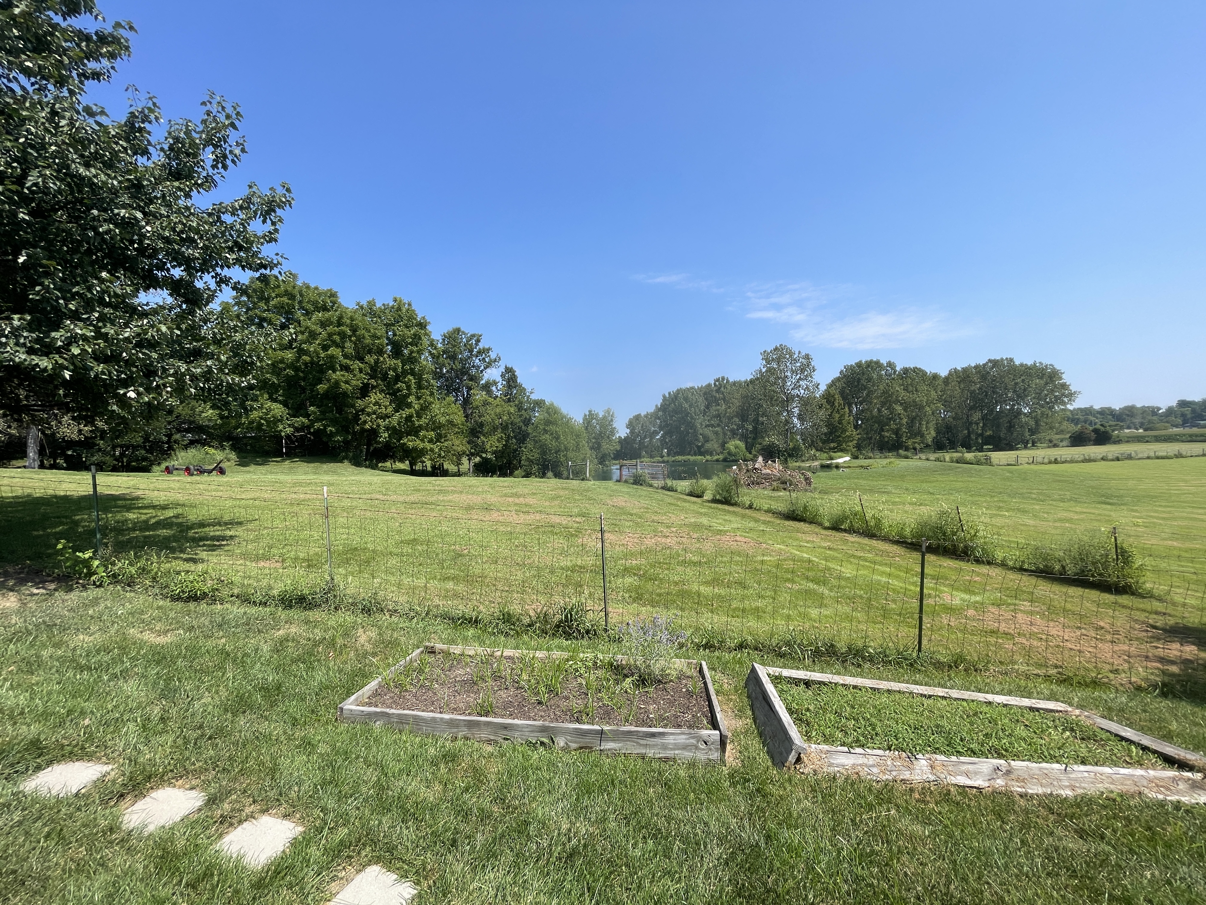 Spacious backyard with garden beds and peaceful country views
