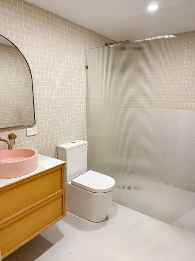 Textured glass shower, pink vessel sink