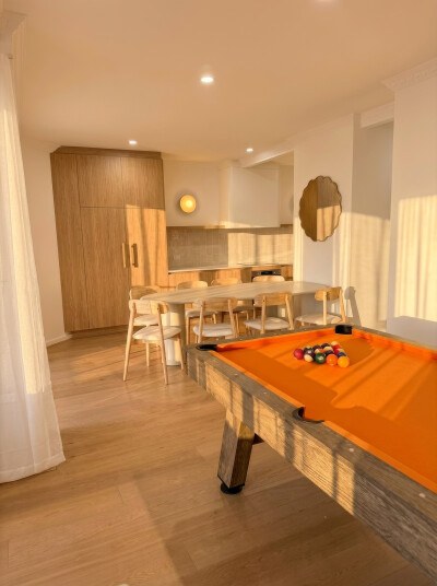 Games room at golden hour — pool table and dining