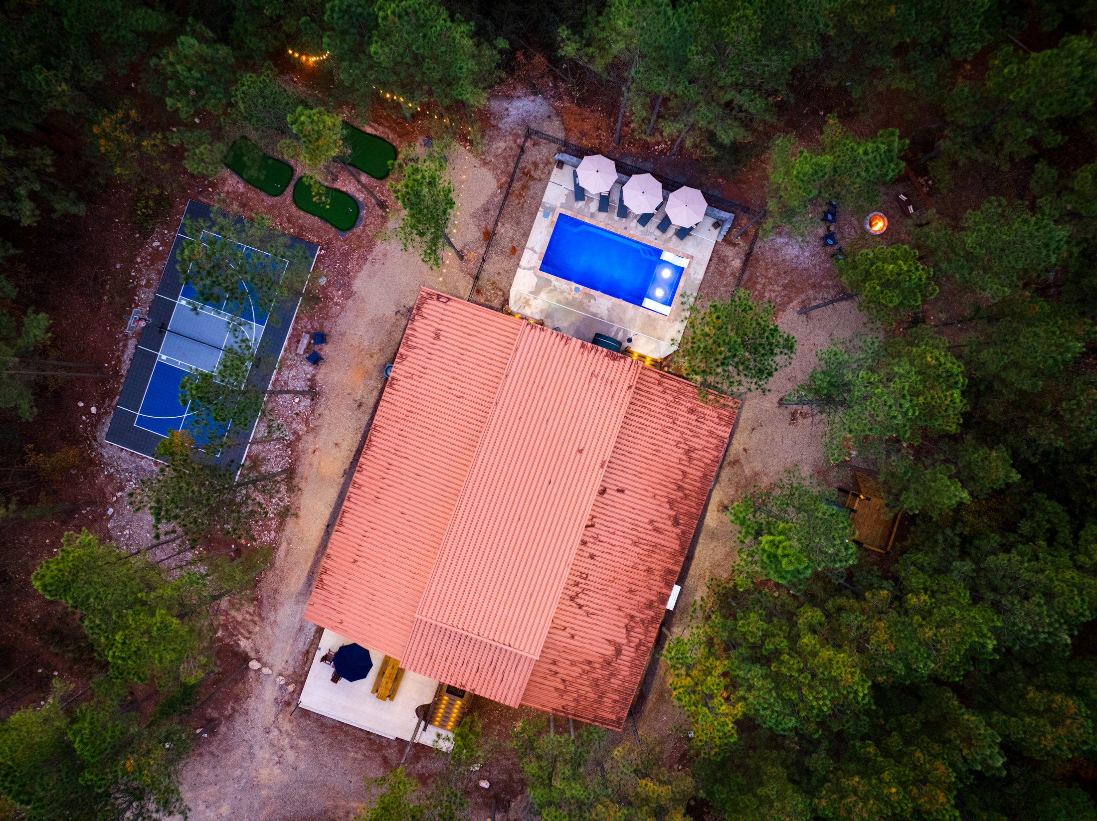 Private woodland escape with pool, sports court, and fire pit