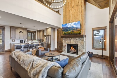 Settle into the warm glow of the fireplace after skiing at Sugar or exploring Banner Elk. This open living space invites cozy movie nights, family meals, and long conversations with mountain views framed just beyond the windows.
