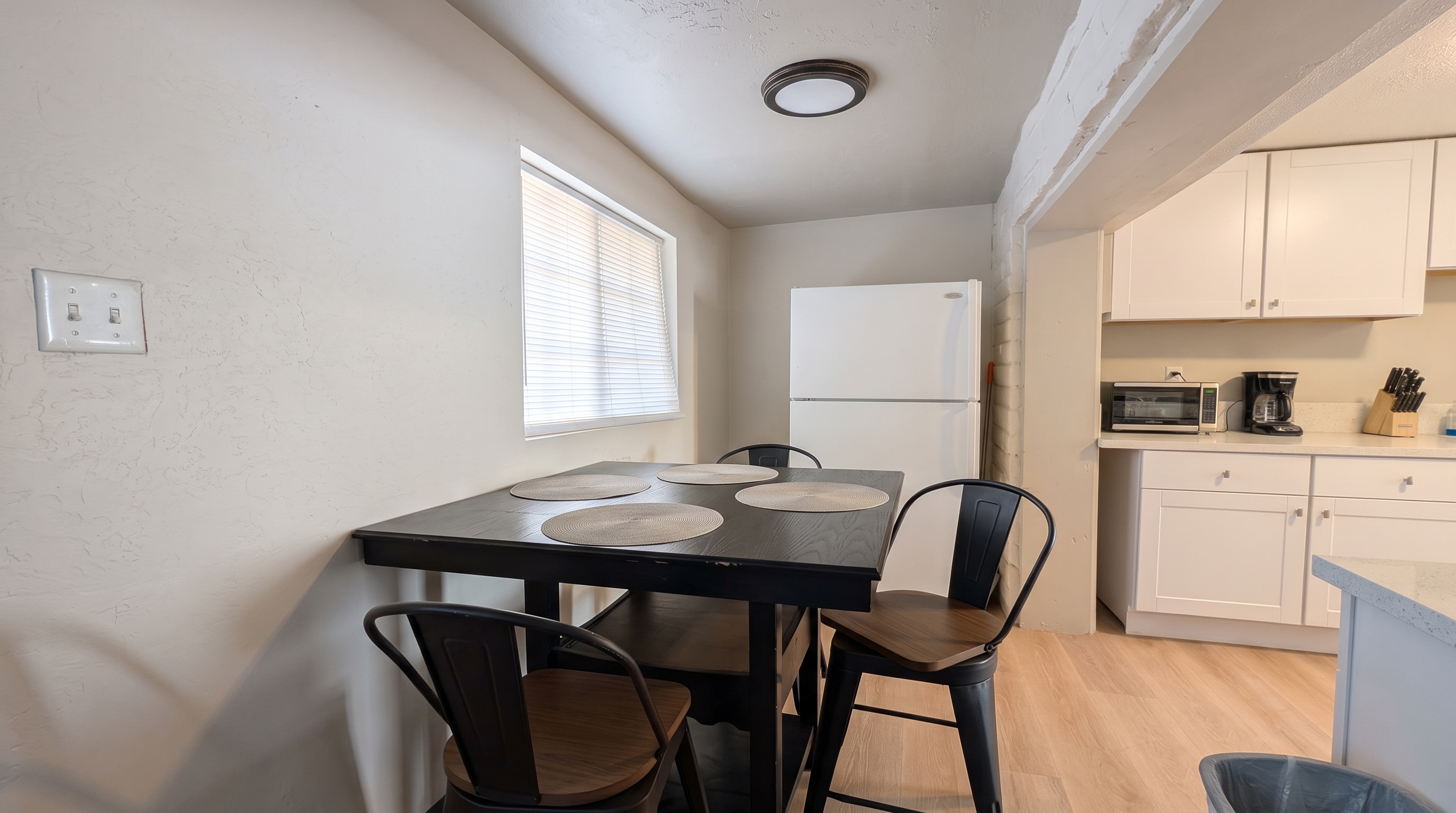 Cozy dining nook beside a bright, fully equipped kitchen