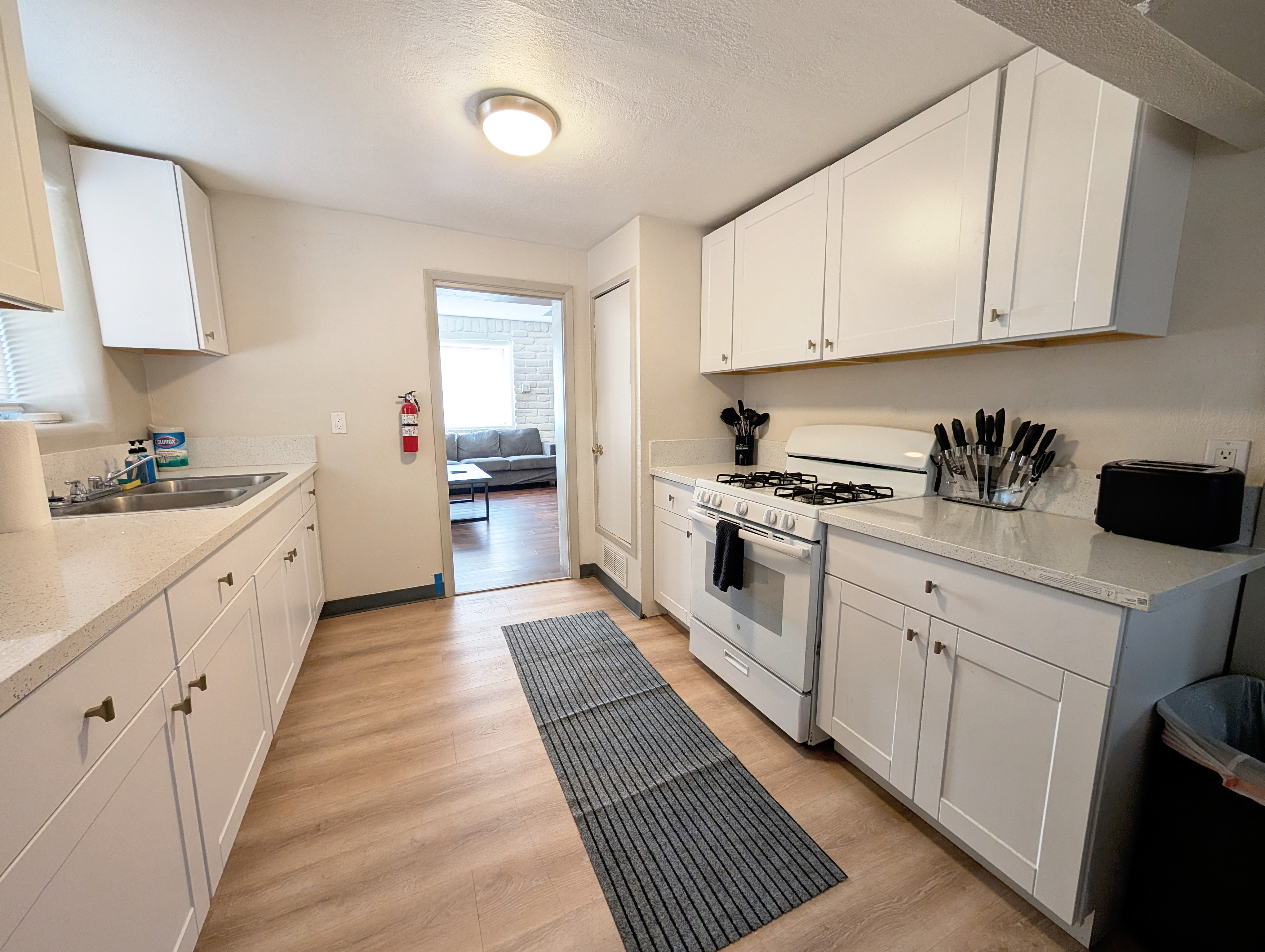 Bright modern galley kitchen with gas stove and ample cabinet space