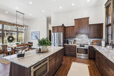 A fully equipped kitchen offers stainless steel appliances, generous counter space, and everything needed for cooking meals at home, whether preparing quick breakfasts or hosting large family dinners.