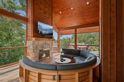 Curl up on the curved sectional around the stone fireplace in this screened, treehouse-style lounge — flip on the mounted TV or just take in the layered forest canopy from up high.
