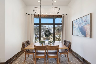 The dining area comfortably seats the group for shared meals, game nights, or celebrations, with plenty of space and natural light enhancing every gathering.