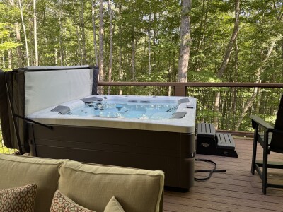 Private hot tub on a peaceful wooded deck retreat