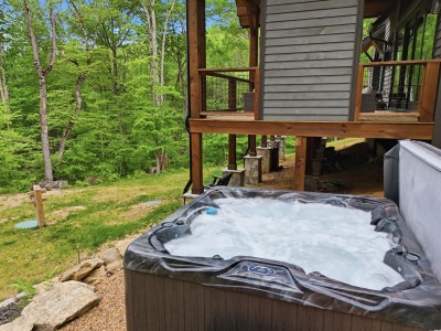 Private hot tub with serene wooded views and cozy cabin ambiance