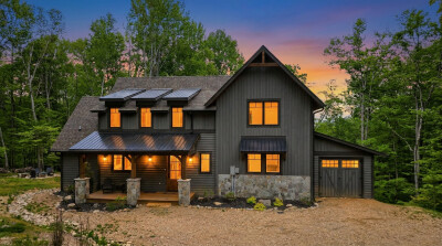 Modern woodland retreat with warm sunset views and inviting curb appeal