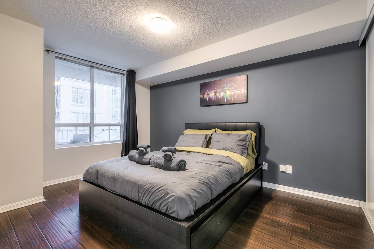 Peaceful bedroom with a plush queen bed and blackout curtains