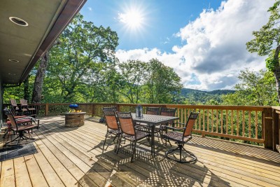 This spacious mountain deck offers outdoor dining, lounge seating, and sweeping views of the surrounding Blue Ridge scenery. Ideal for morning coffee, shared meals, or relaxing evenings surrounded by nature and fresh mountain air.