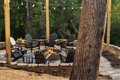 Gather at the woodland fire pit patio, ringed by Adirondack chairs and twinkling string lights. Roast marshmallows, swap stories, and soak in the mountain night air on this spacious retreat's most laid-back hangout spot.
