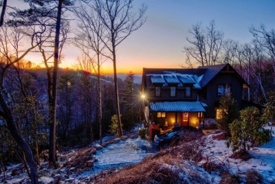 Twilight settles over the mountains as warm light glows from the windows, welcoming you home after a day of adventure. It feels peaceful, private, and just magical enough to make every evening unforgettable.