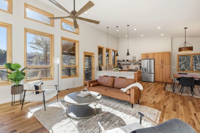 Feel instantly at home in this airy living space where comfort meets design. Plush seating, high ceilings, and warm wood accents create the perfect setting to relax after a day of adventure.