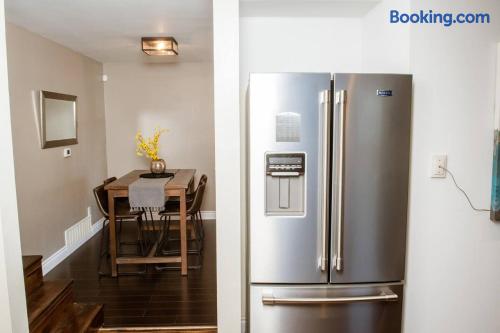 Modern dining nook and stainless steel fridge with sleek, inviting style