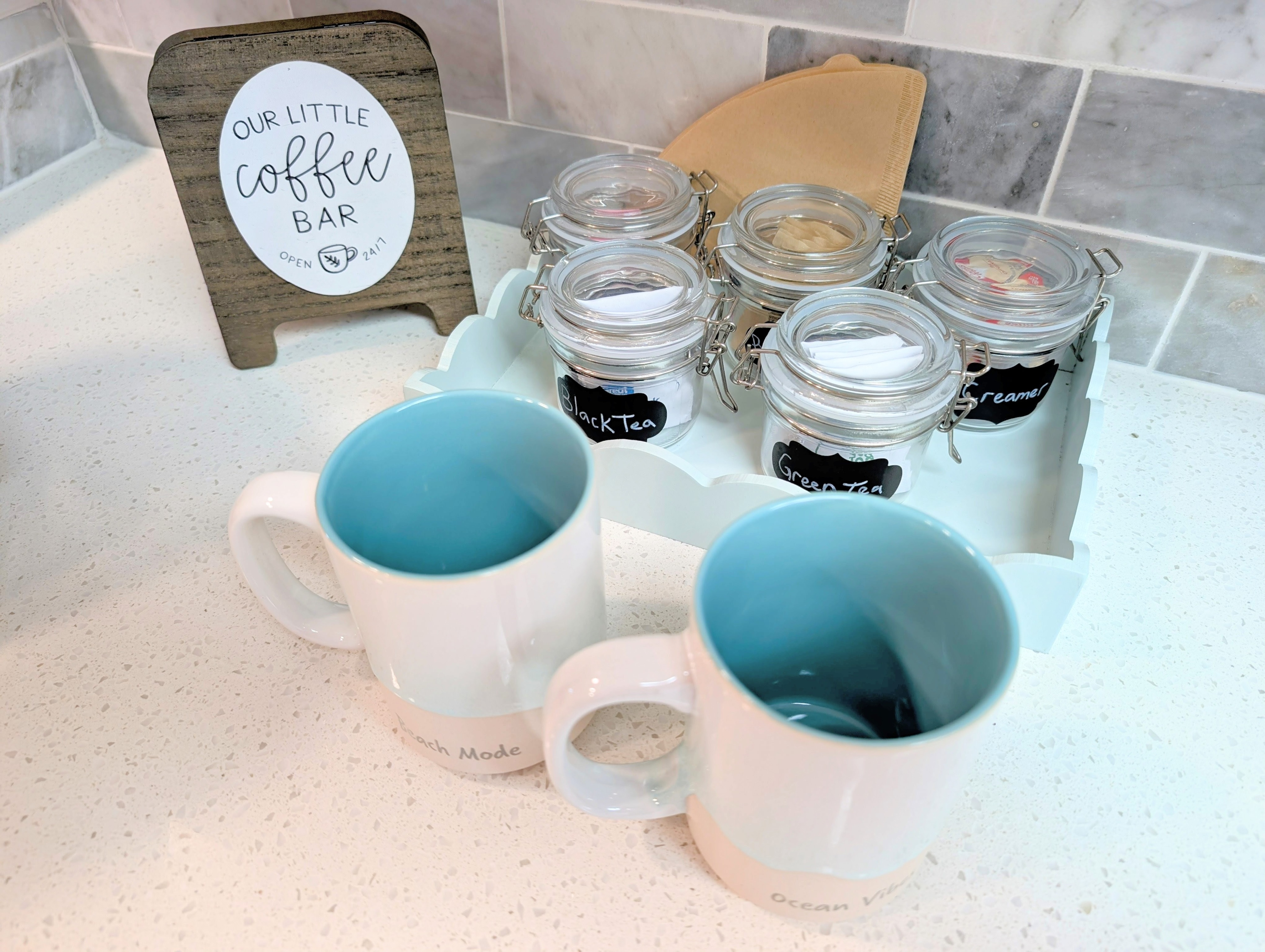 Charming coffee & tea bar - labeled jars, mugs, filters, and all the fixings.