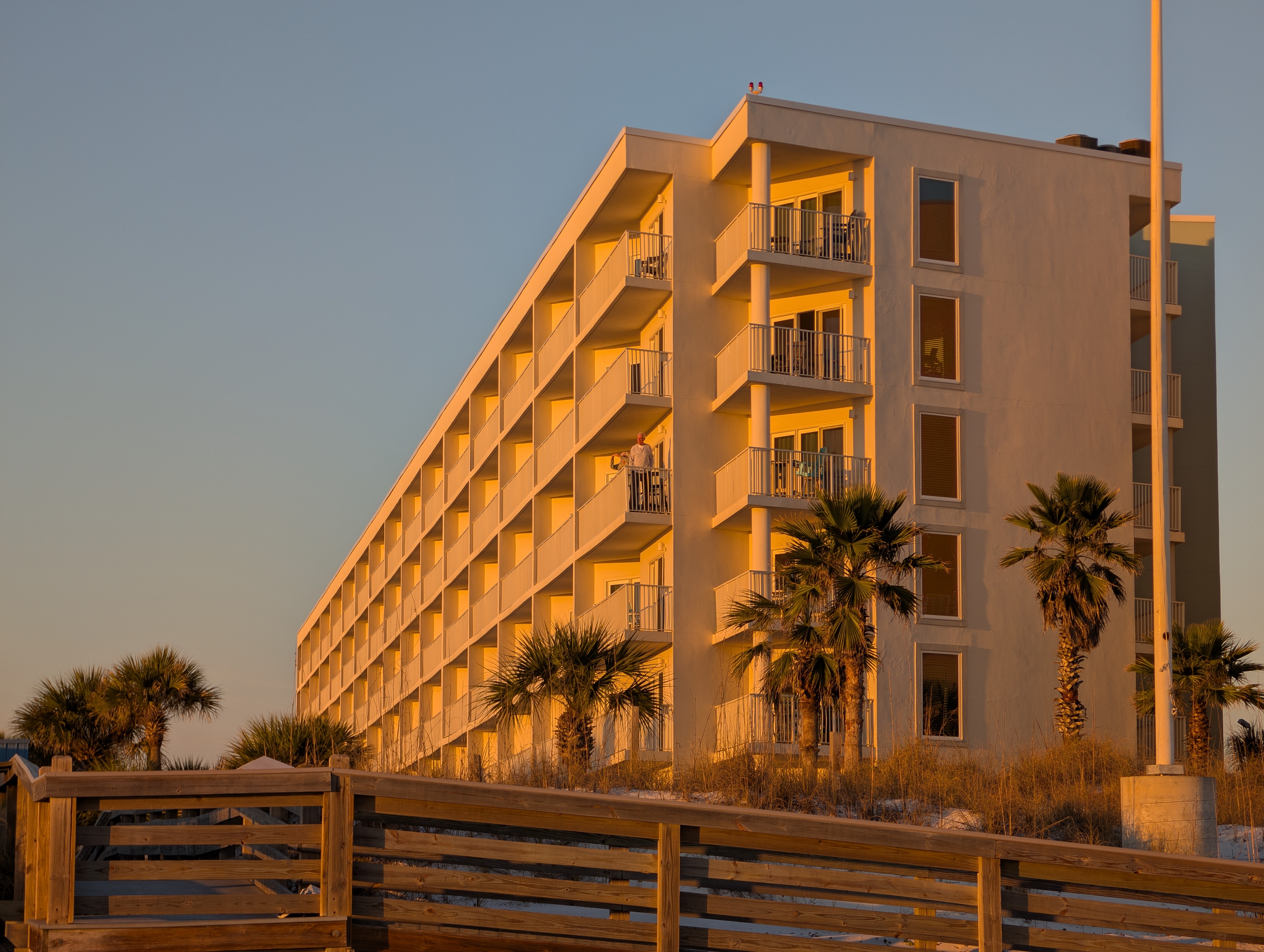 Golden-hour beachfront condo with private balconies and boardwalk access