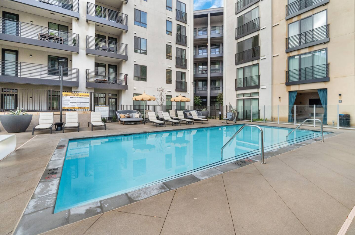 Resort-style courtyard pool with loungers and modern urban ambiance