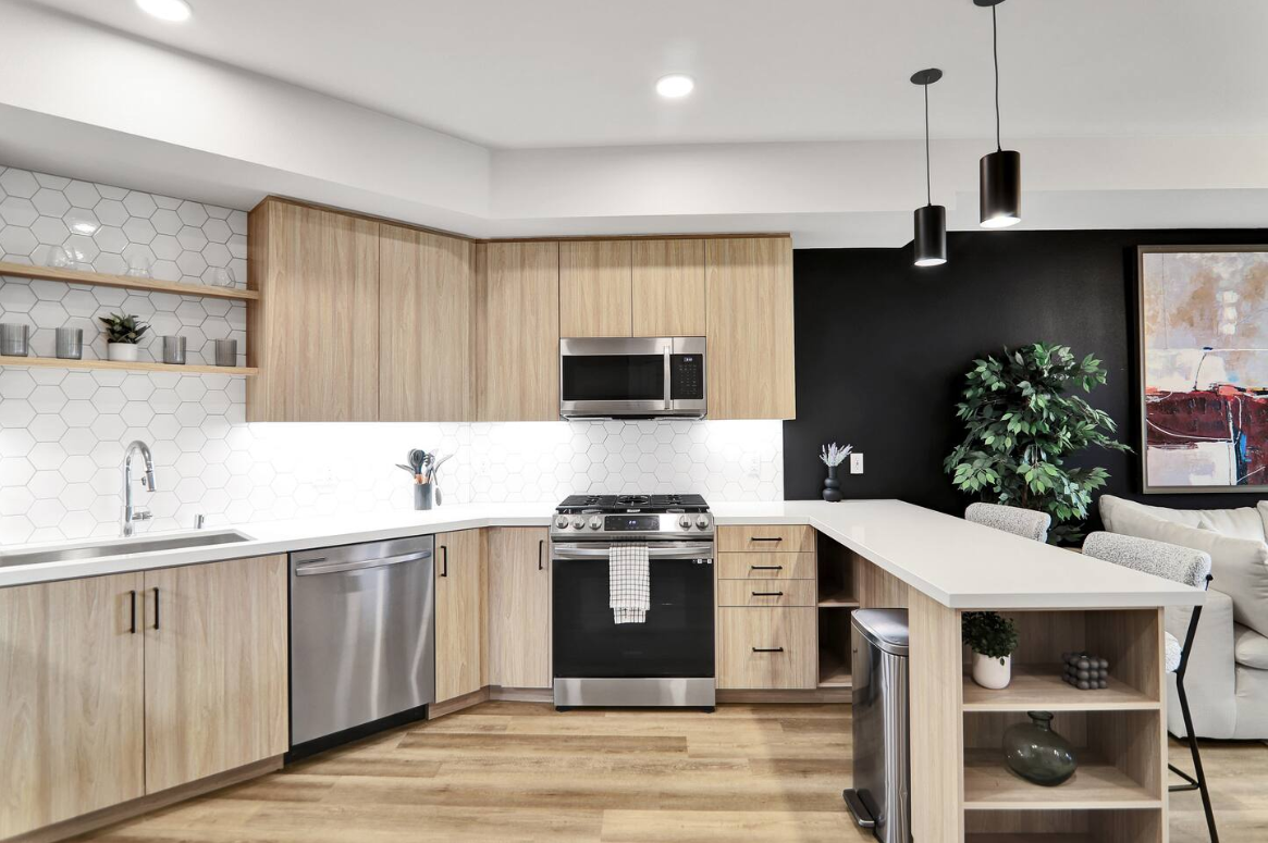 Modern kitchen with peninsula seating, stainless appliances, and stylish finishes