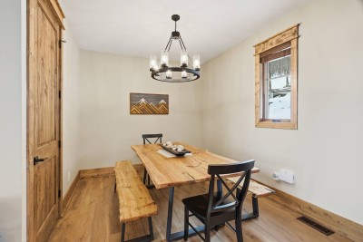 The warm wood dining table invites shared meals, laughter, and connection. Thoughtful lighting and an open layout make this space feel both intimate and welcoming.