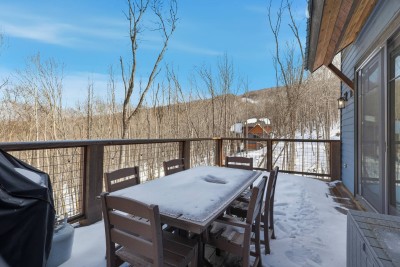 Dine outdoors with peaceful forest views all around. Even in winter, this spacious deck feels serene and private, offering a beautiful backdrop for morning coffee or evening drinks.