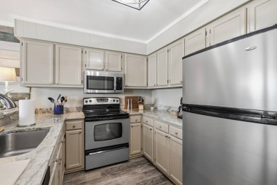 The kitchen is equipped with modern appliances and ample storage, making it easy for guests to cook meals, store groceries, and enjoy extended stays comfortably.