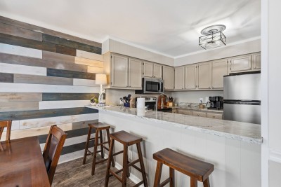 Prepare meals with ease in the fully equipped kitchen featuring modern appliances, generous counter space, and convenient bar seating for casual breakfasts or evening conversations.