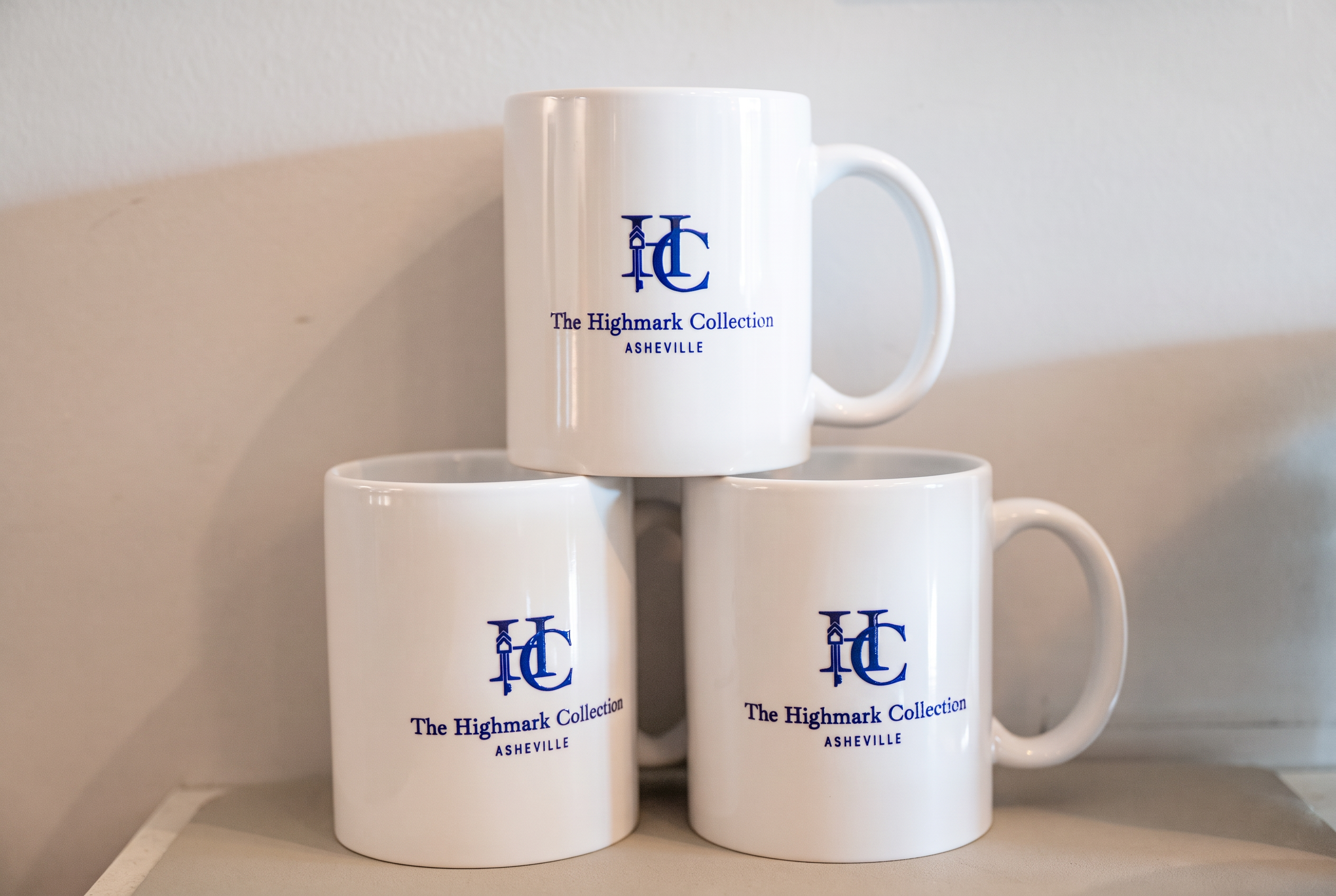 Branded ceramic mugs add a polished, boutique coffee station touch