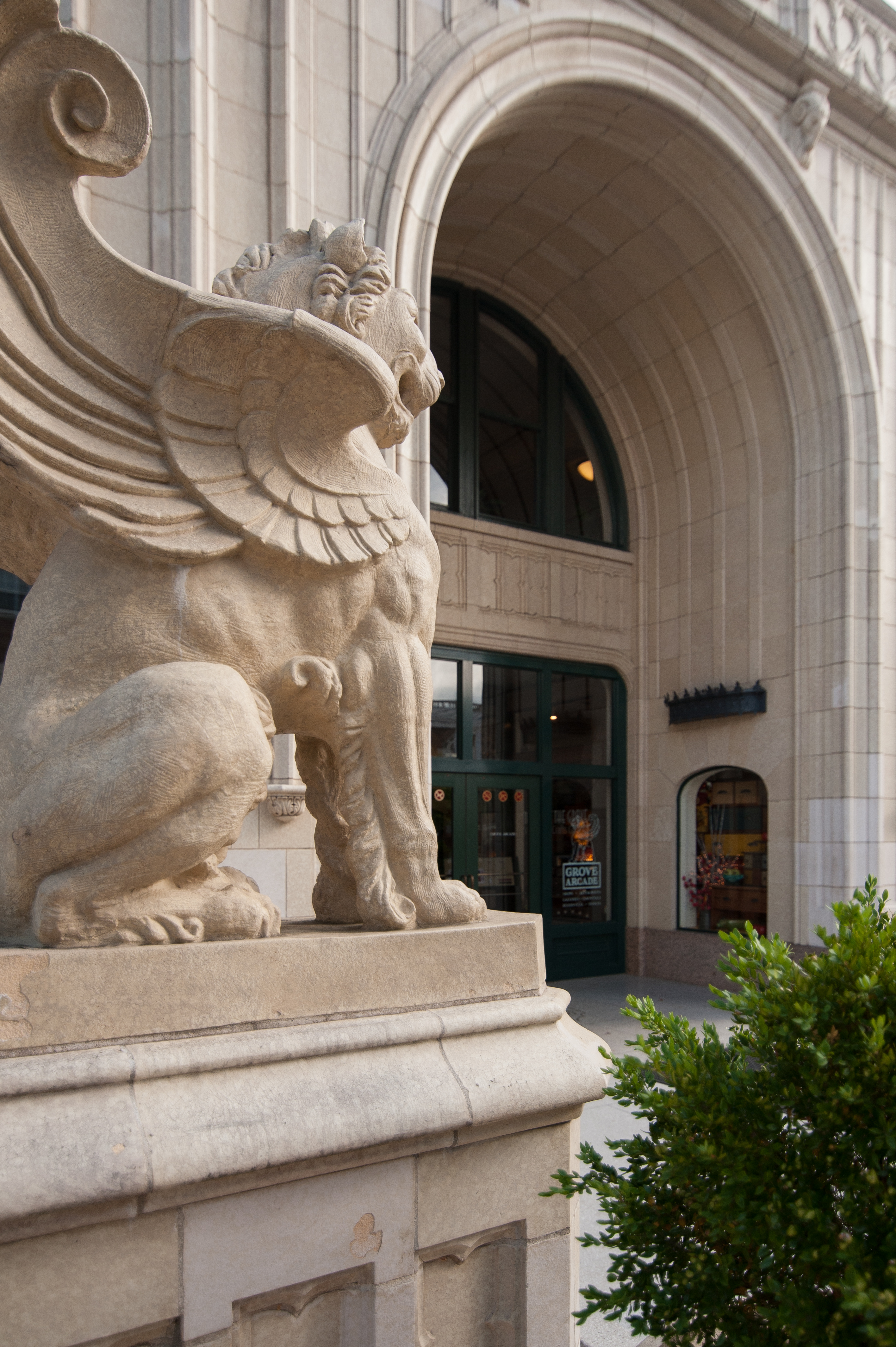 Grand historic entrance with striking stone griffin and elegant architecture