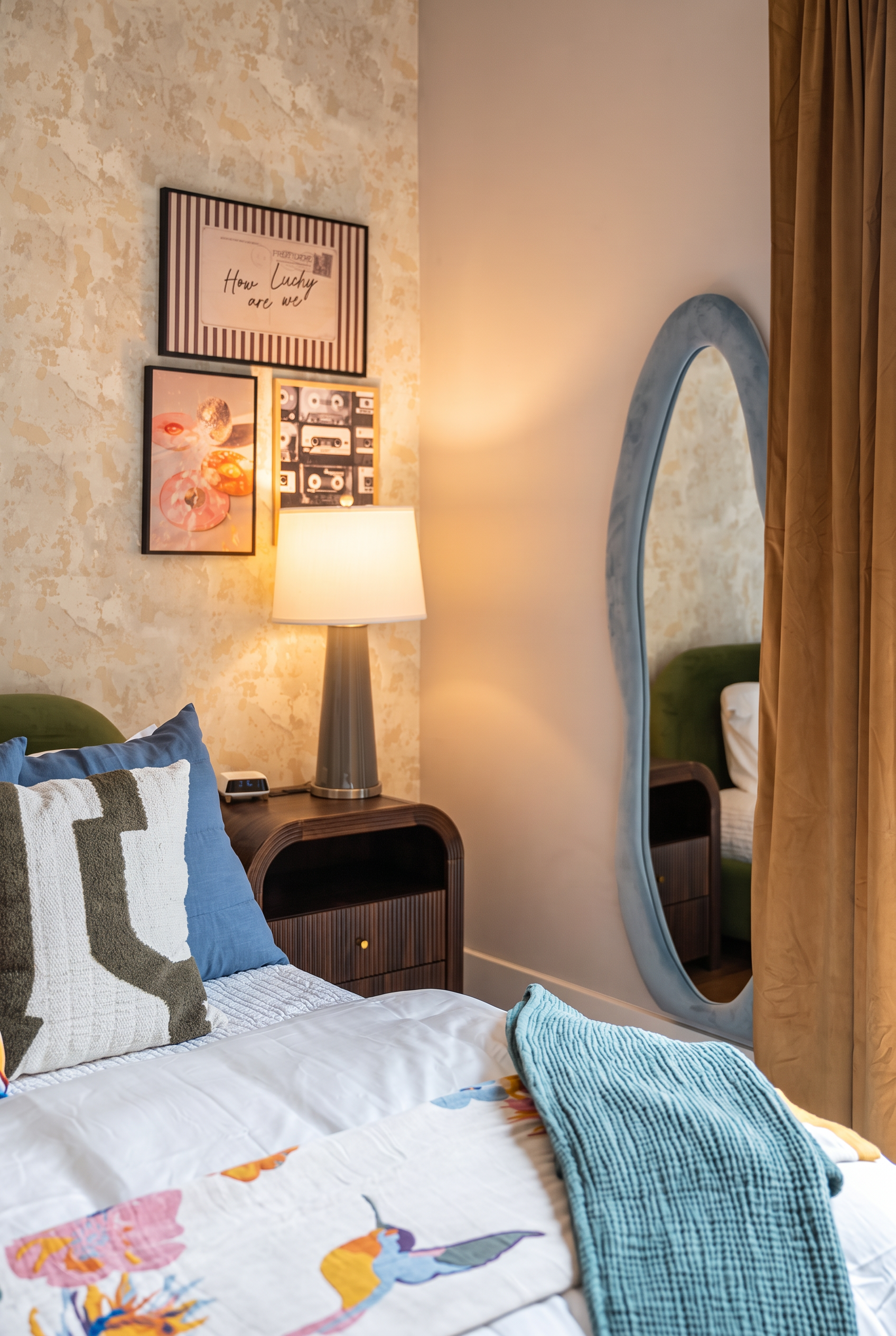 Stylish bedroom with cozy lighting, bold decor, and full-length mirror