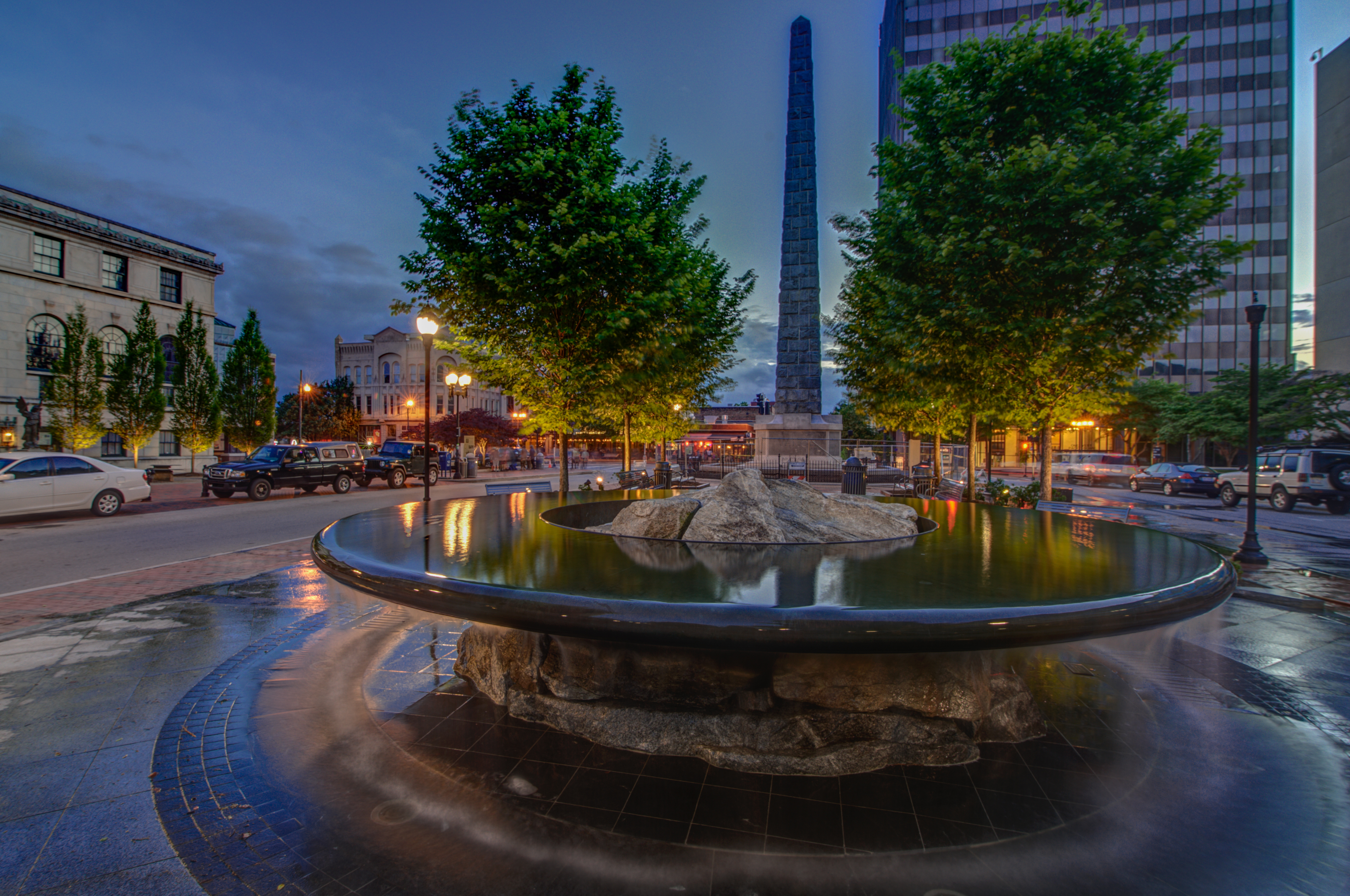 Scenic downtown plaza with elegant fountain and evening city charm