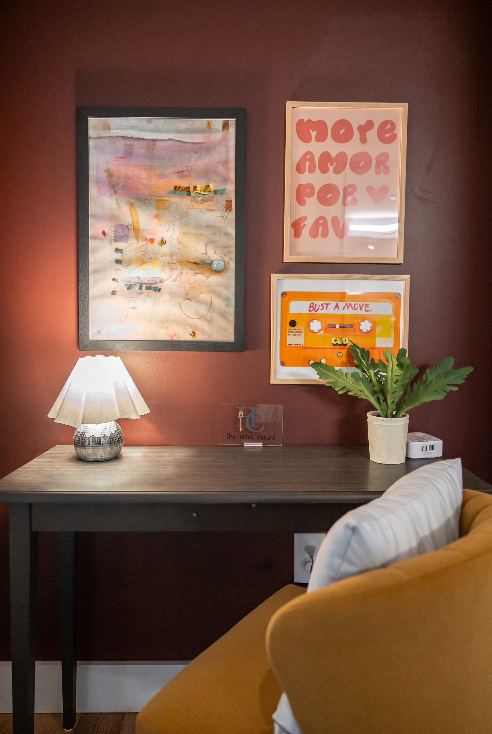 Cozy designer workspace with bold art, warm lighting, and comfy seating
