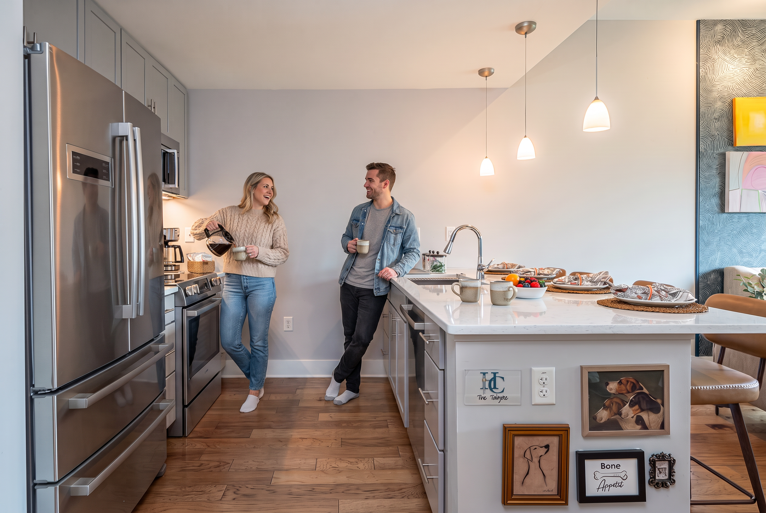 Bright modern kitchen with large island, pendant lighting, and sleek finishes