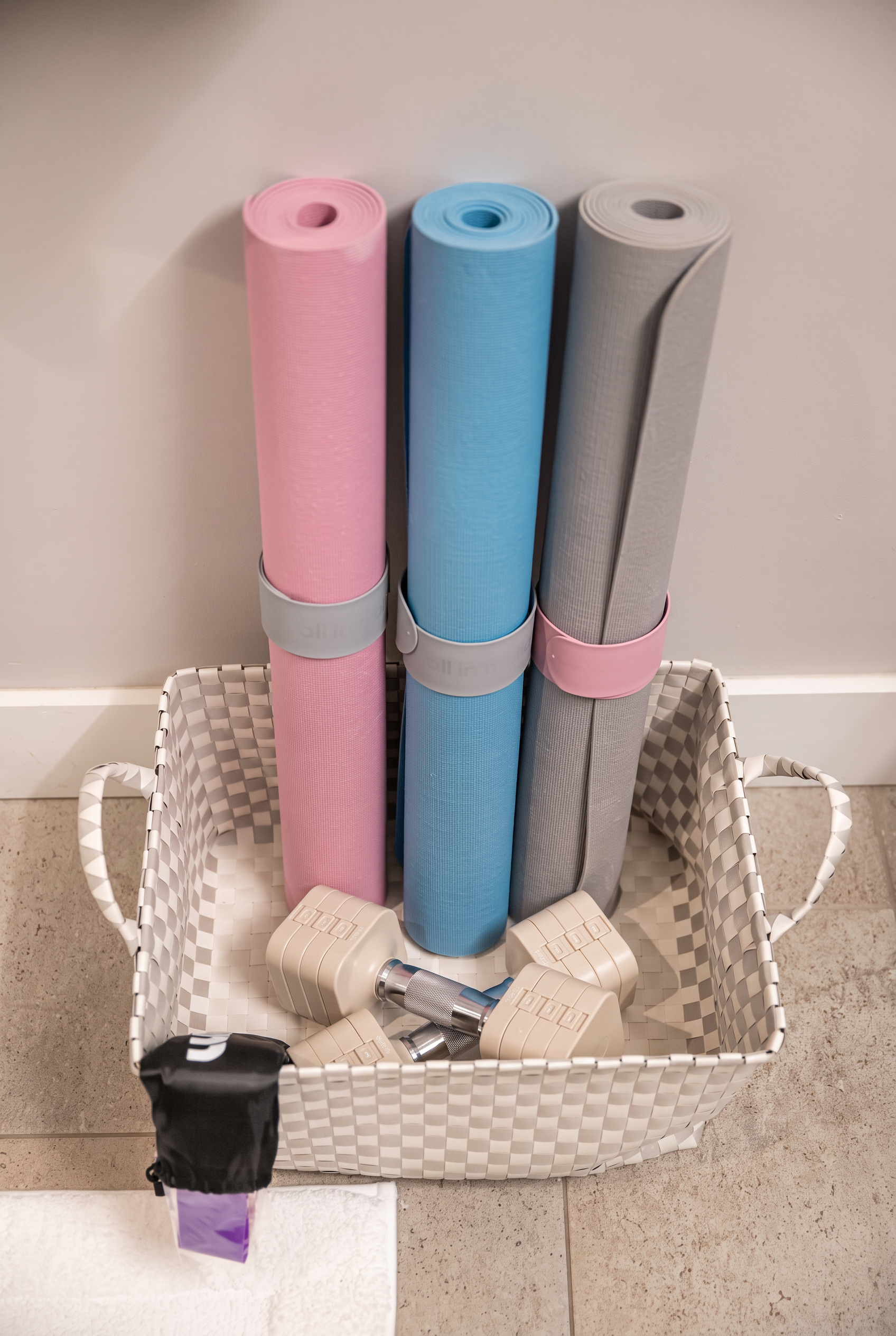 Well-stocked workout nook with yoga mats and light dumbbells