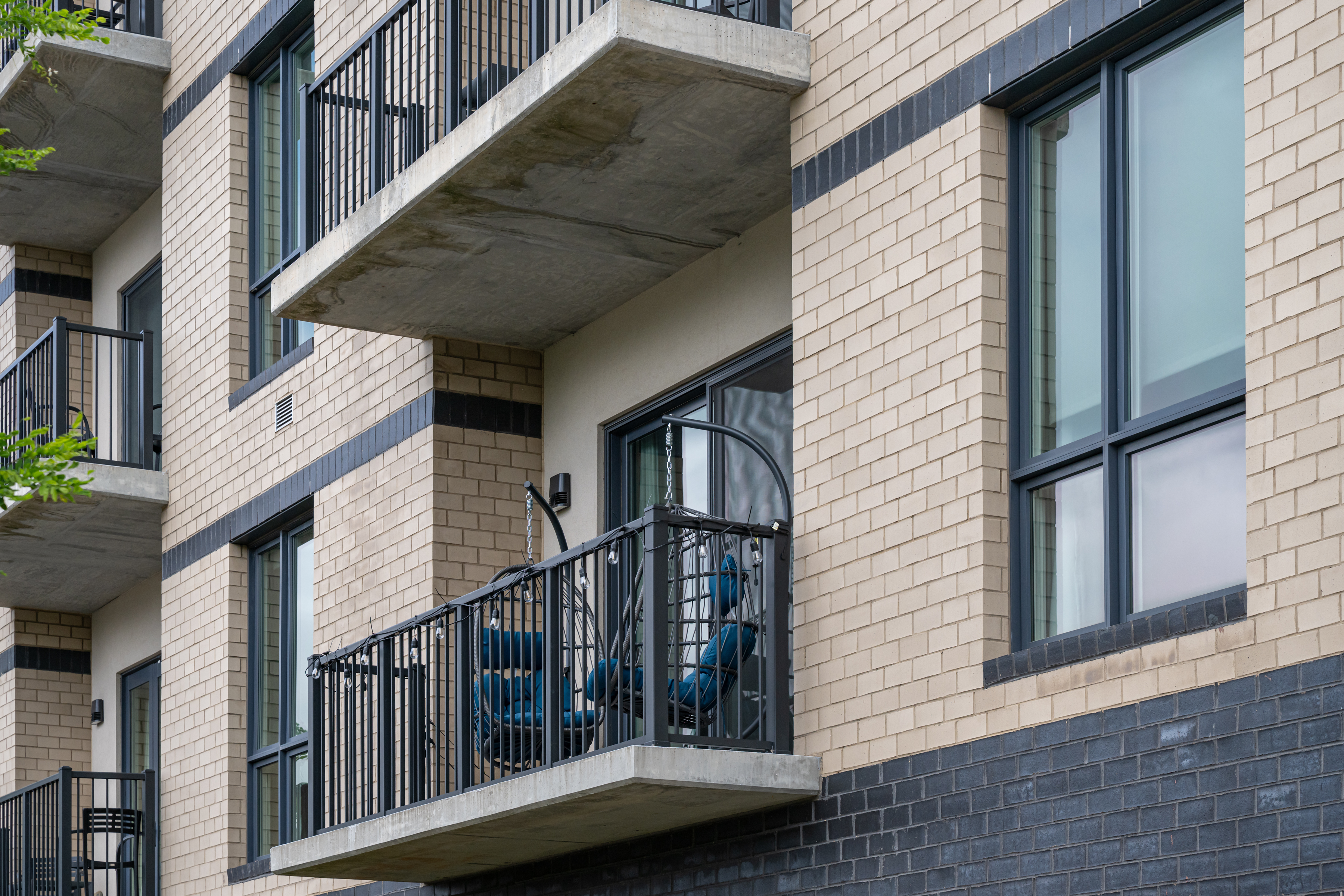 Private furnished balcony on a modern building exterior