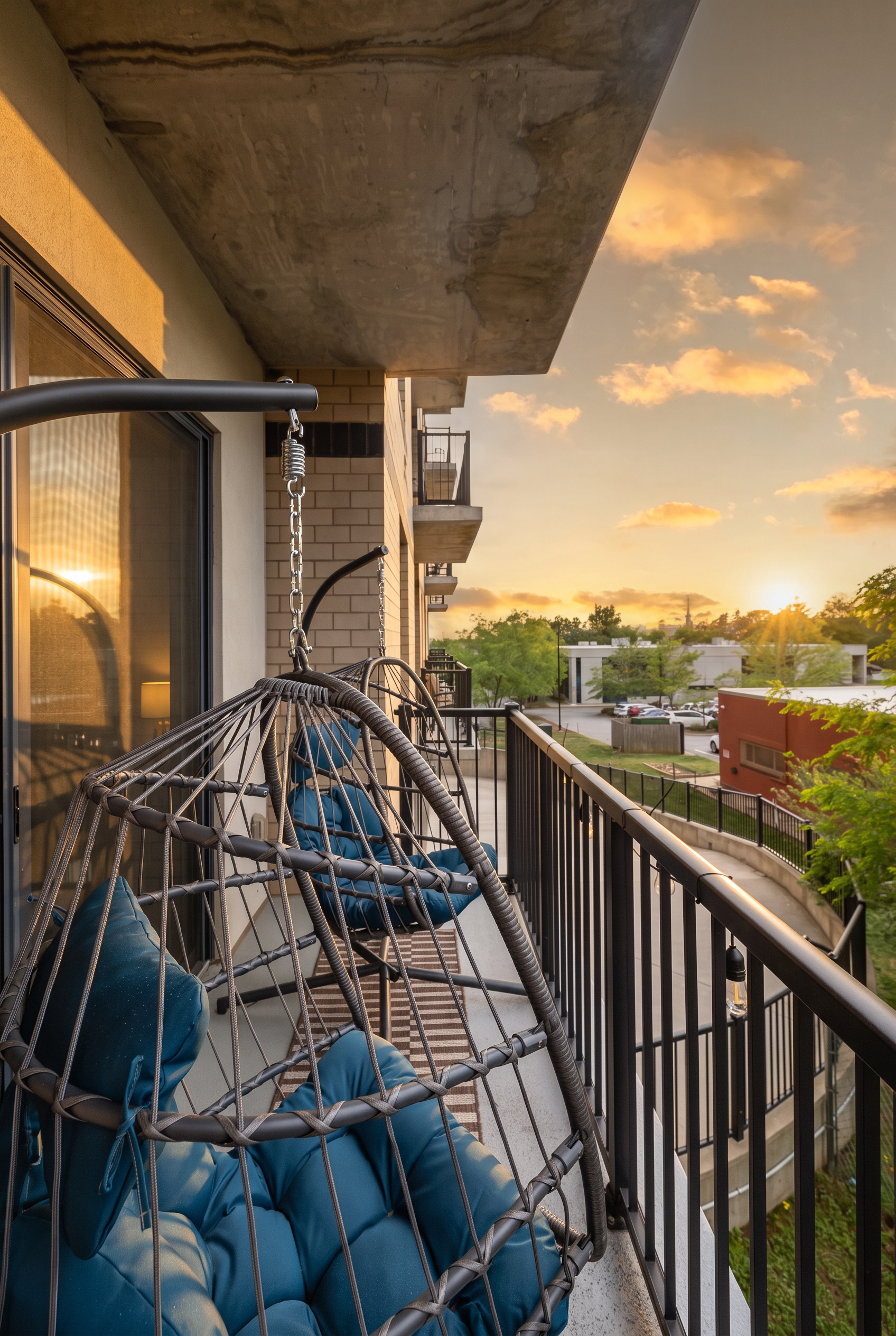 Cozy private balcony with hanging chairs and beautiful sunset views