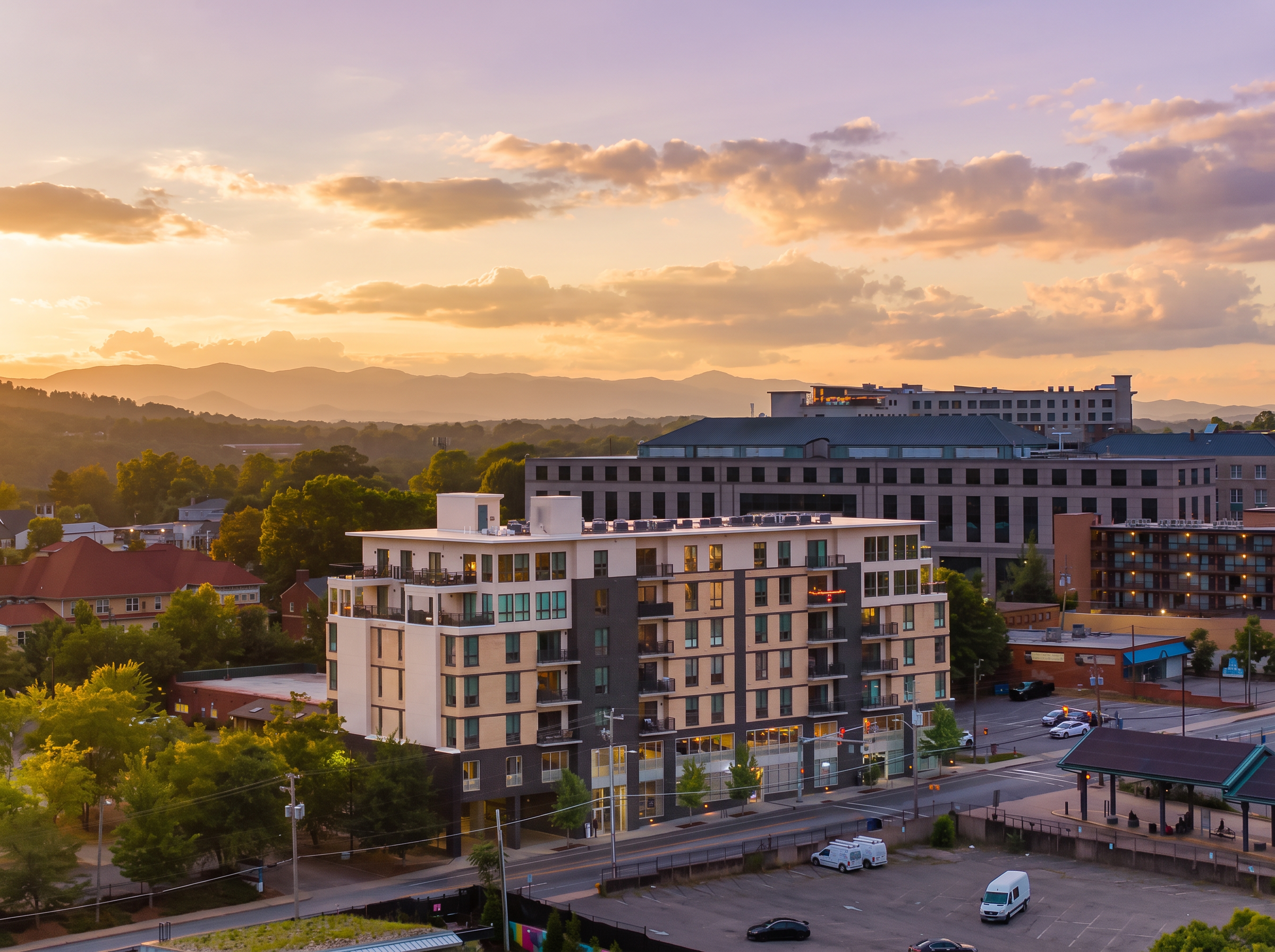 Modern city stay with mountain views and a glowing sunset backdrop