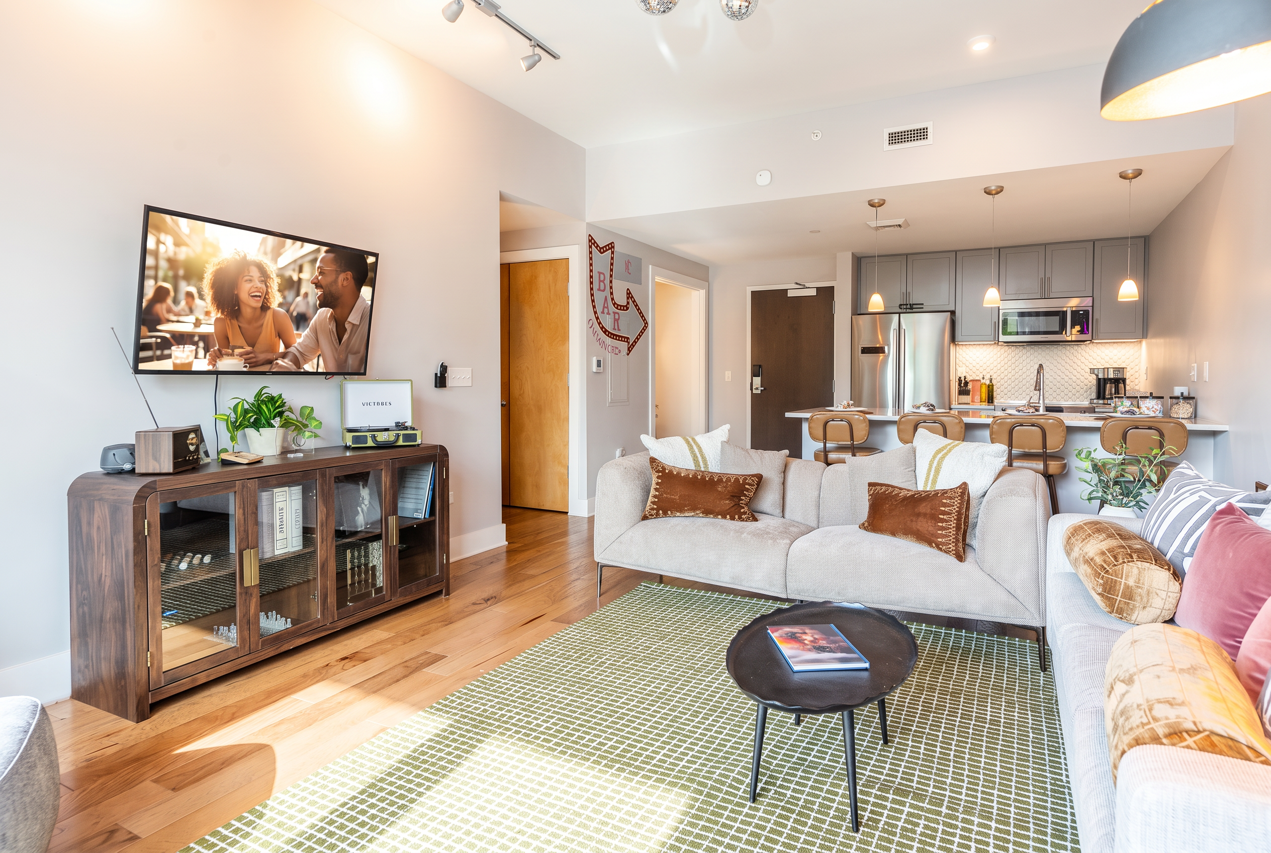 Bright open living room with modern kitchen and stylish lounge seating
