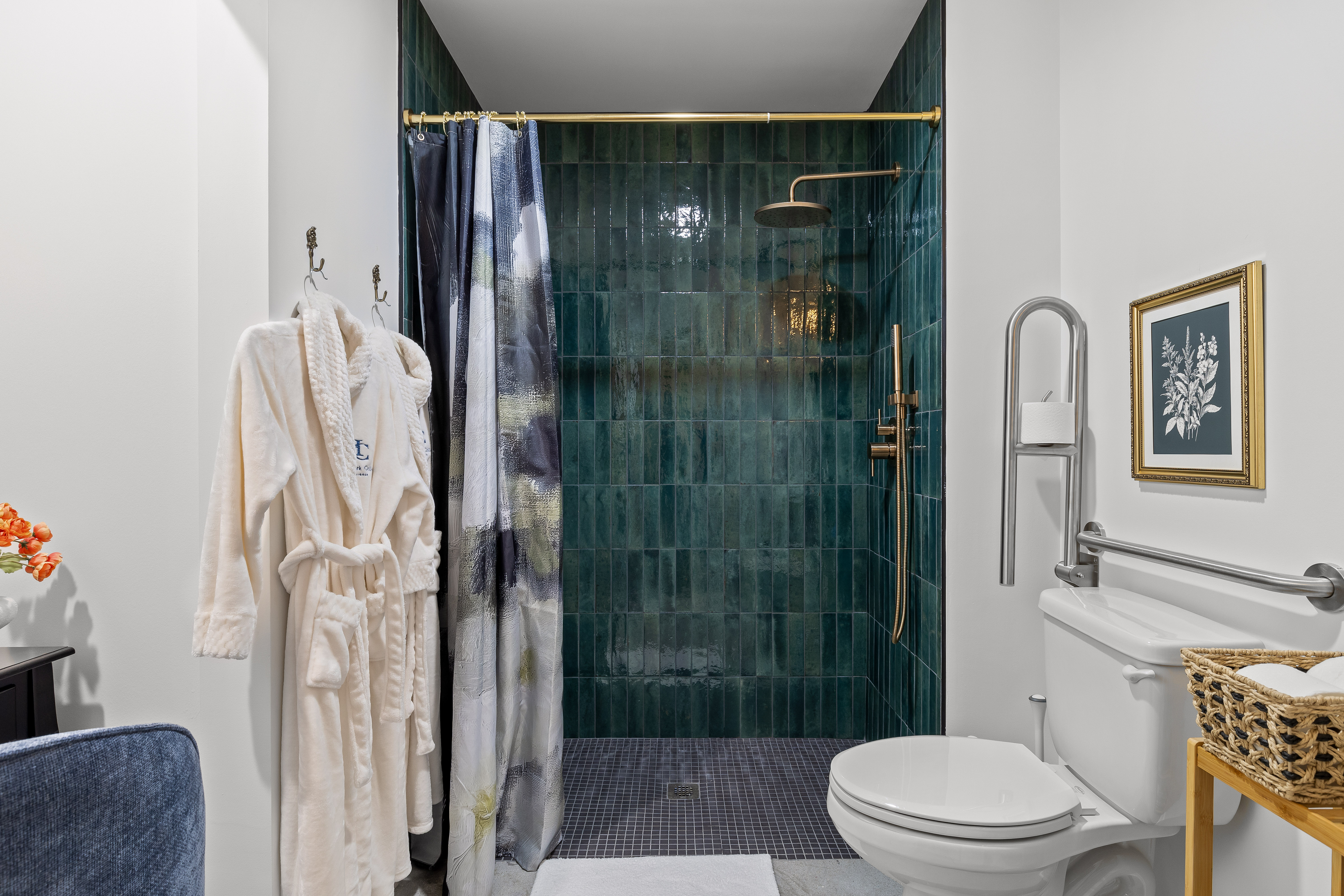 Spa-inspired bathroom with emerald tile shower and luxe brass accents