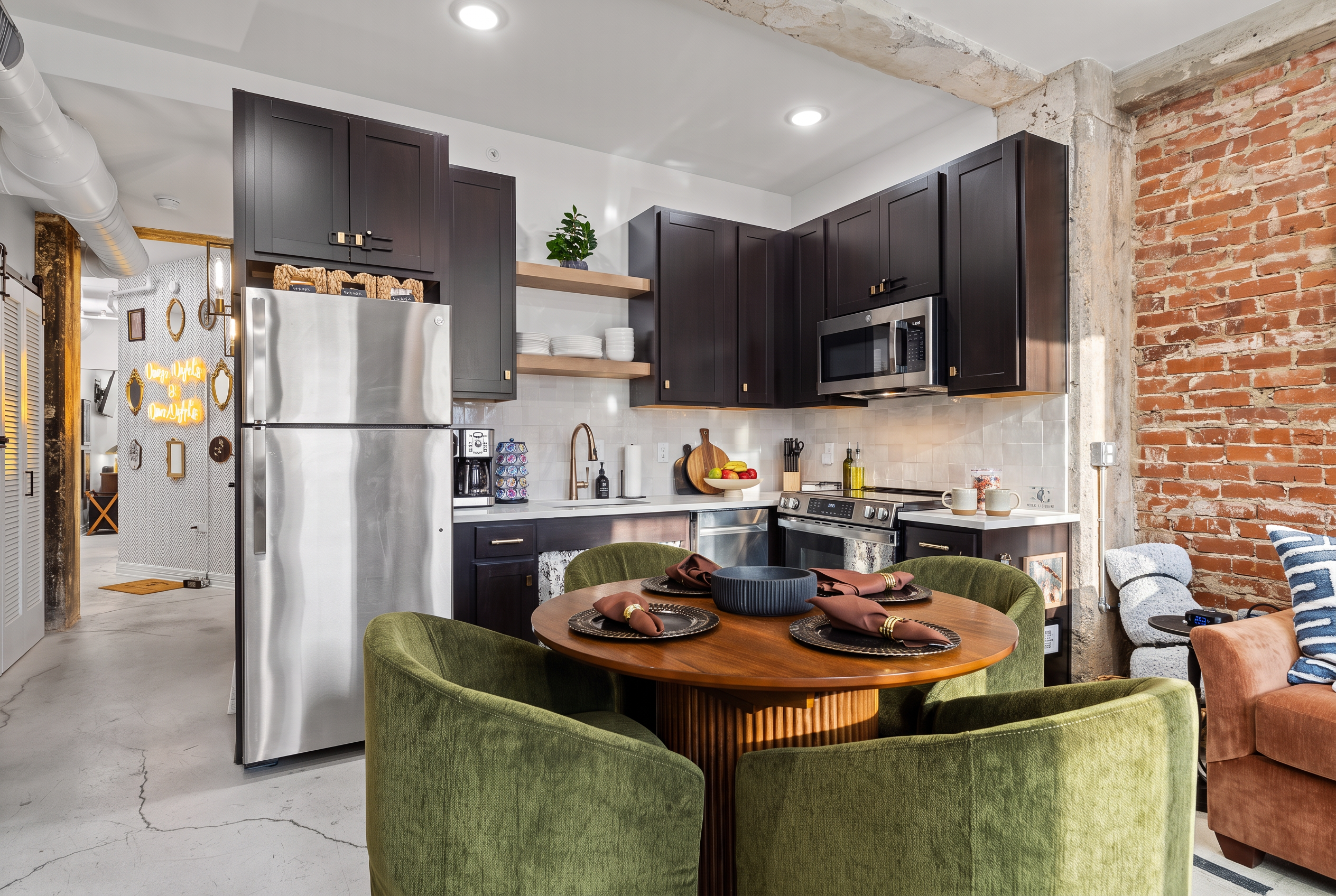 Stylish industrial kitchen with exposed brick and cozy dining for four