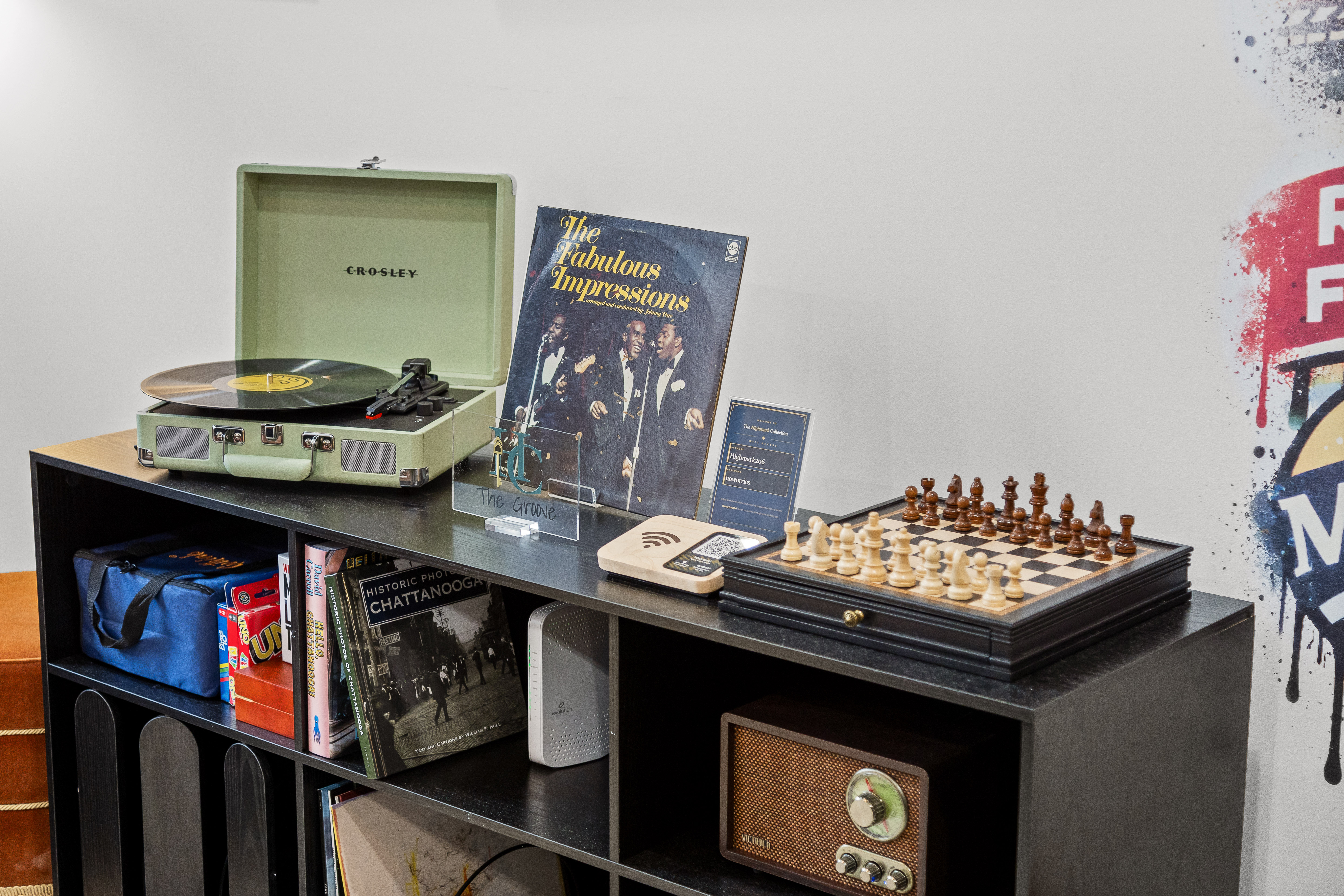 Vintage game and music corner with record player, chess, and cozy lounge vibes