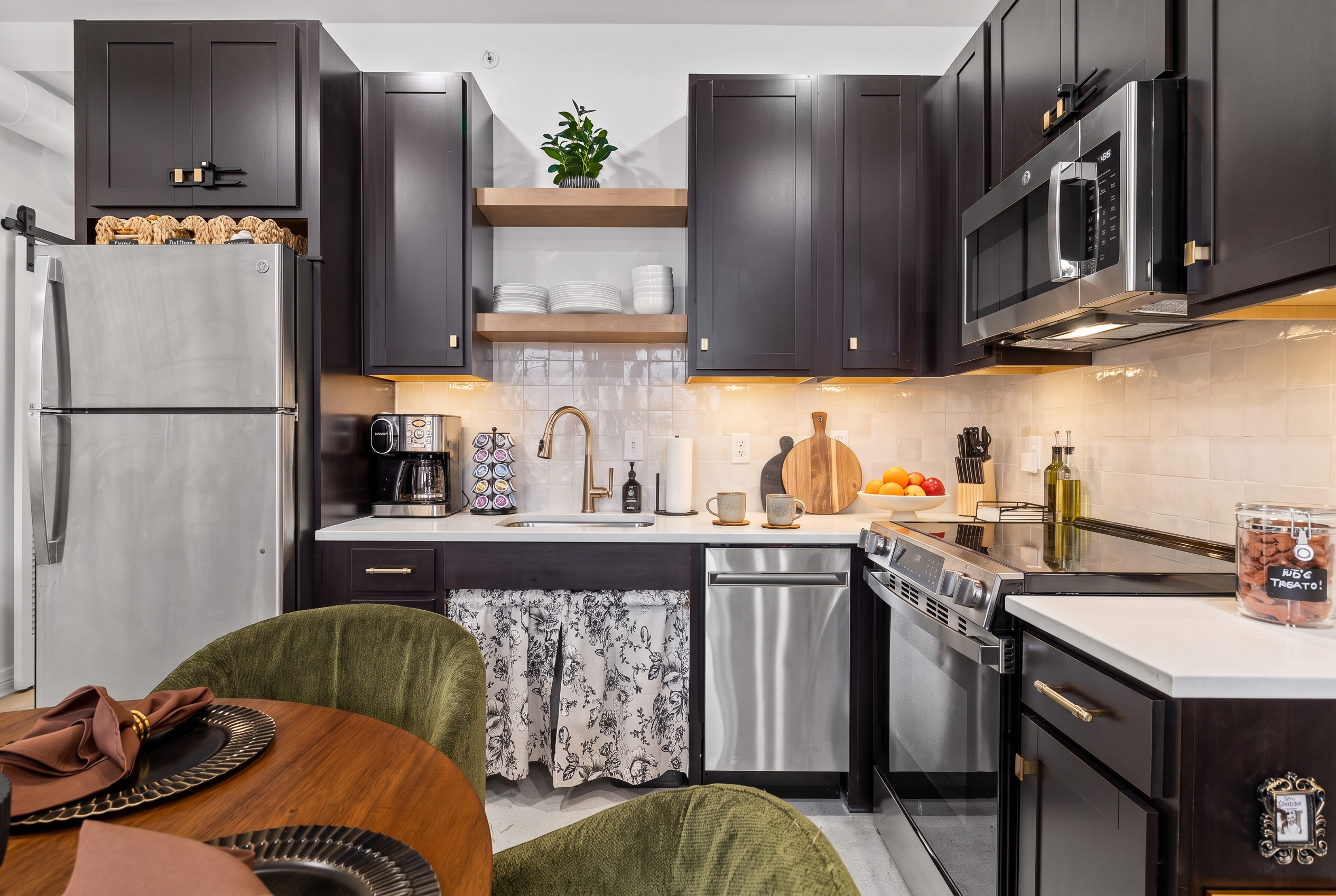 Stylish modern kitchen with stainless appliances and warm designer touches