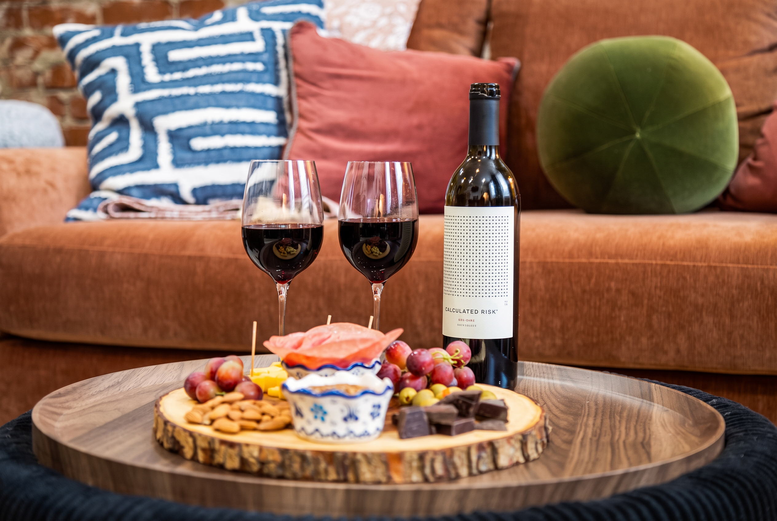 Cozy lounge setup with wine, snacks, and stylish seating