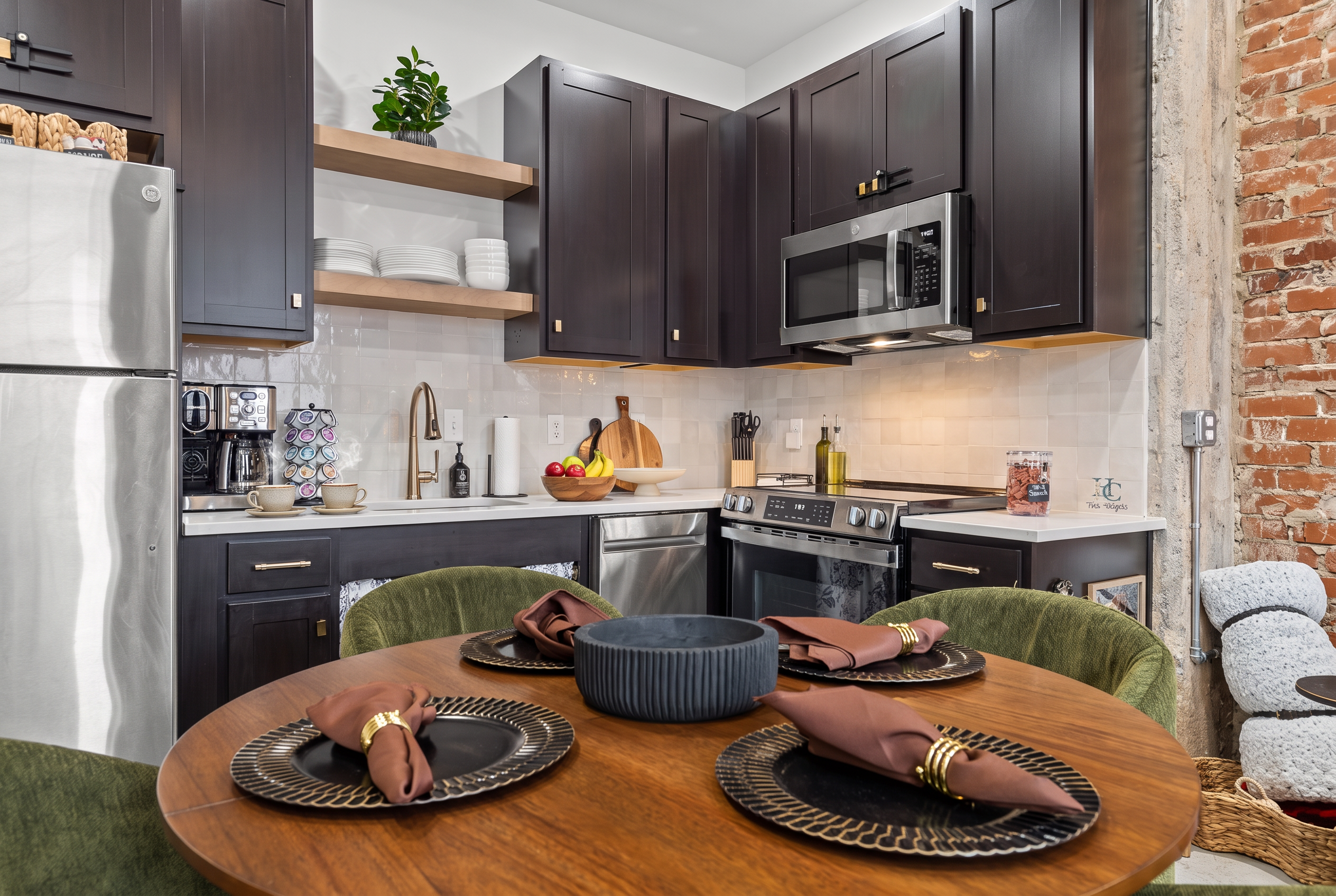 Modern kitchen with exposed brick and a cozy dining space for four
